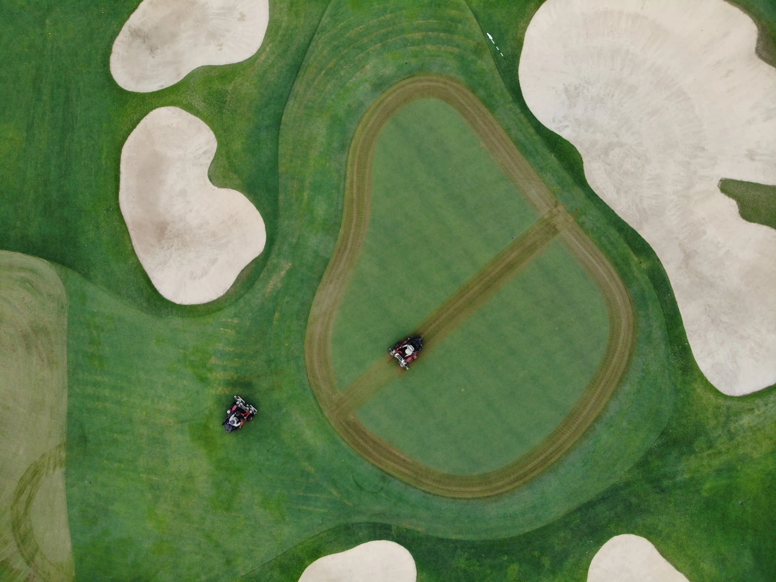 Verticutting the 6th green at Nikanti Golf Club, Thailand. Drone aerial.