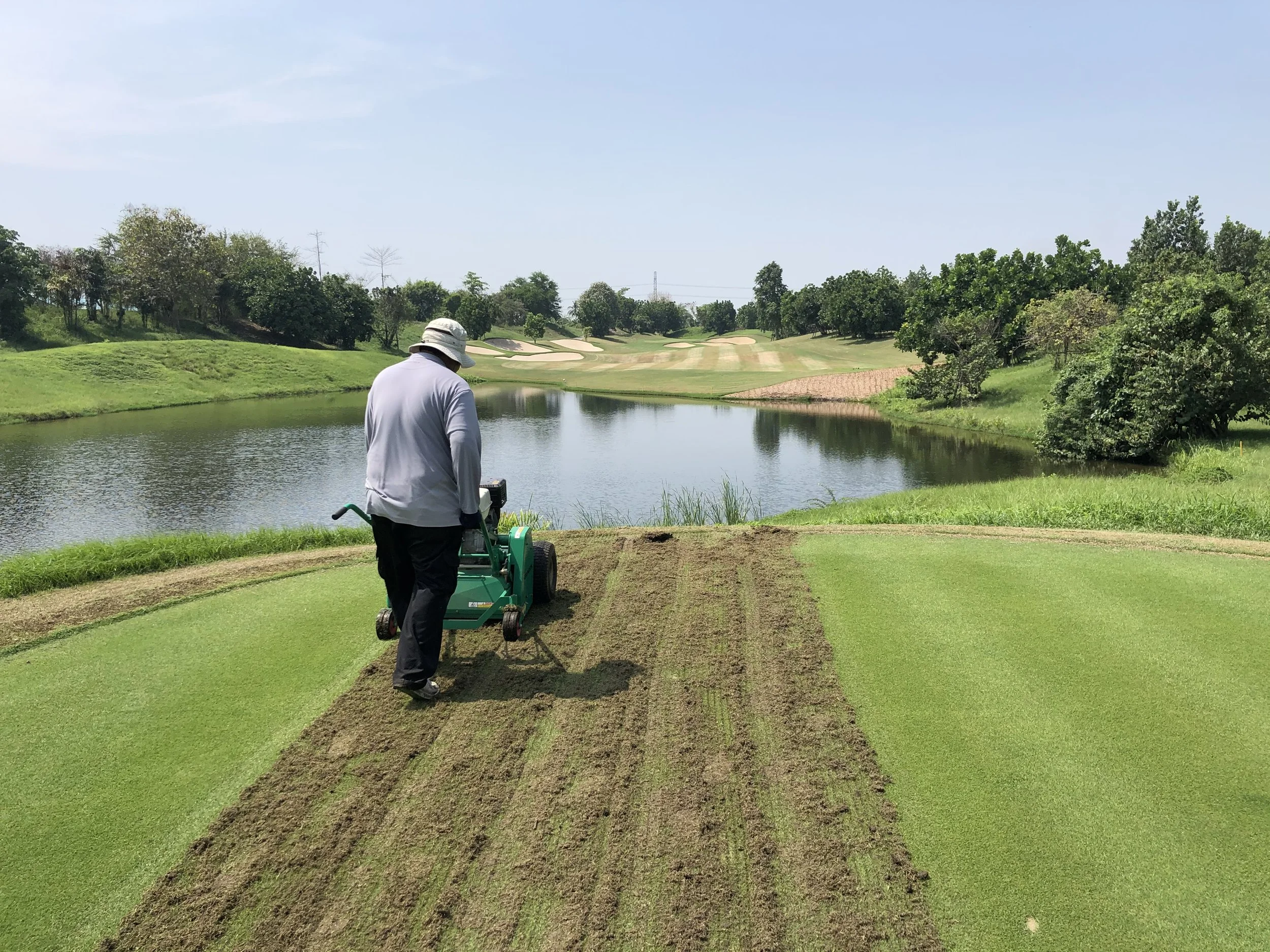 Graden scarifying tee 17 at Nikanti Golf Club, Thailand