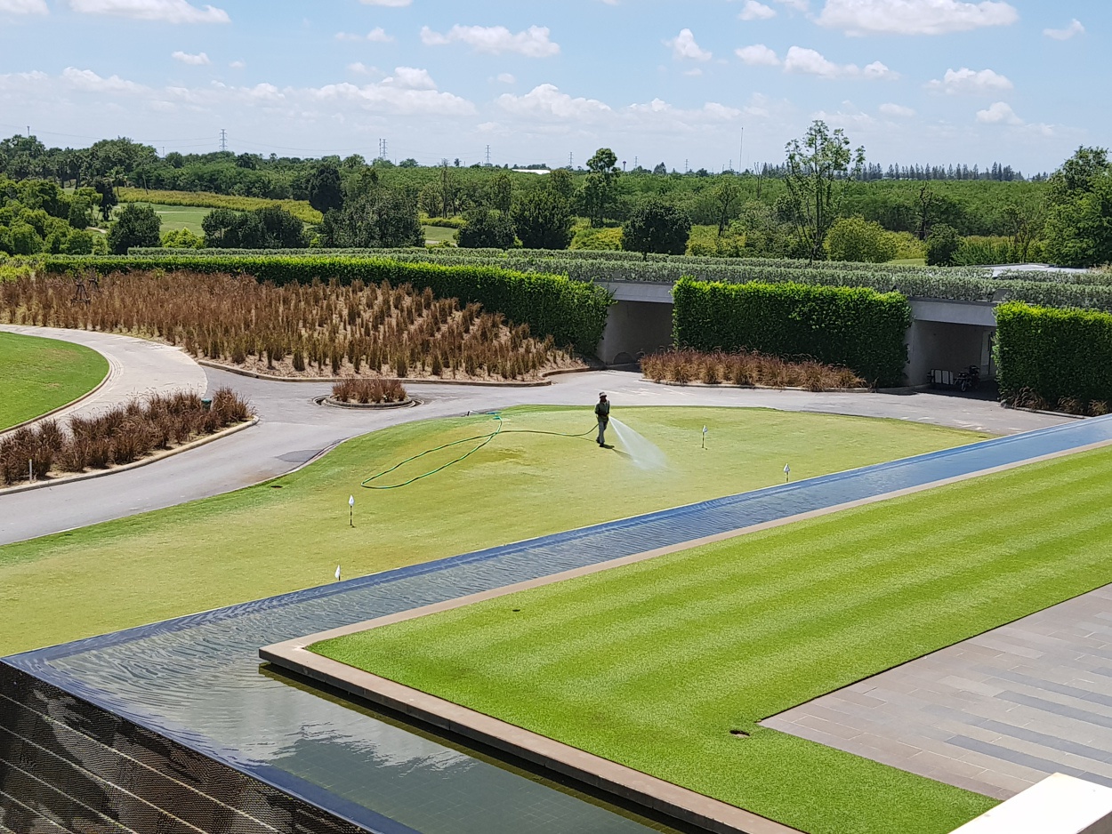 Hand watering the putting green at Nikanti Golf Club
