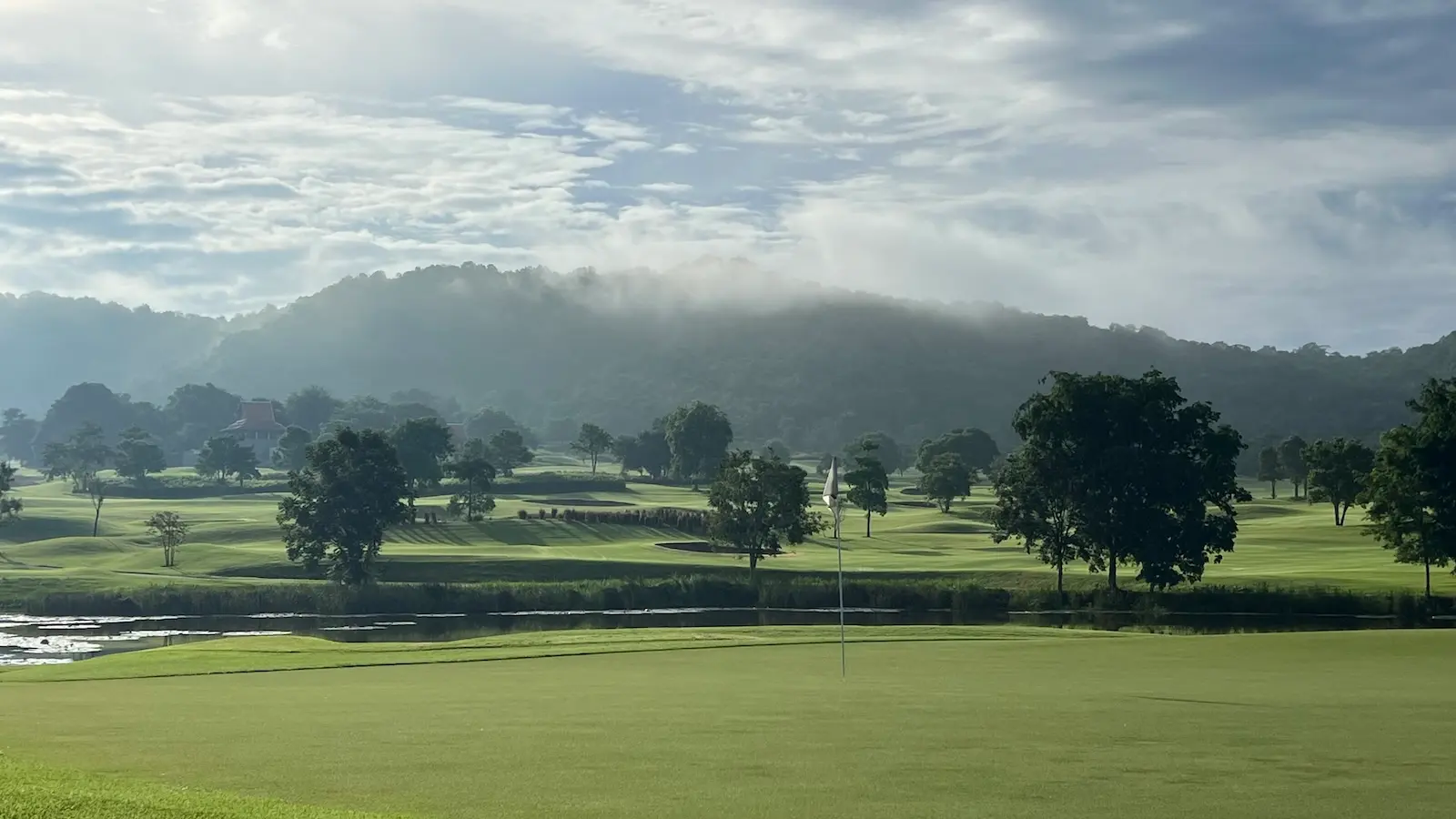 The 4th hole at Pineapple Valley Golf Club in Thailand looking back from the green to the mountains.