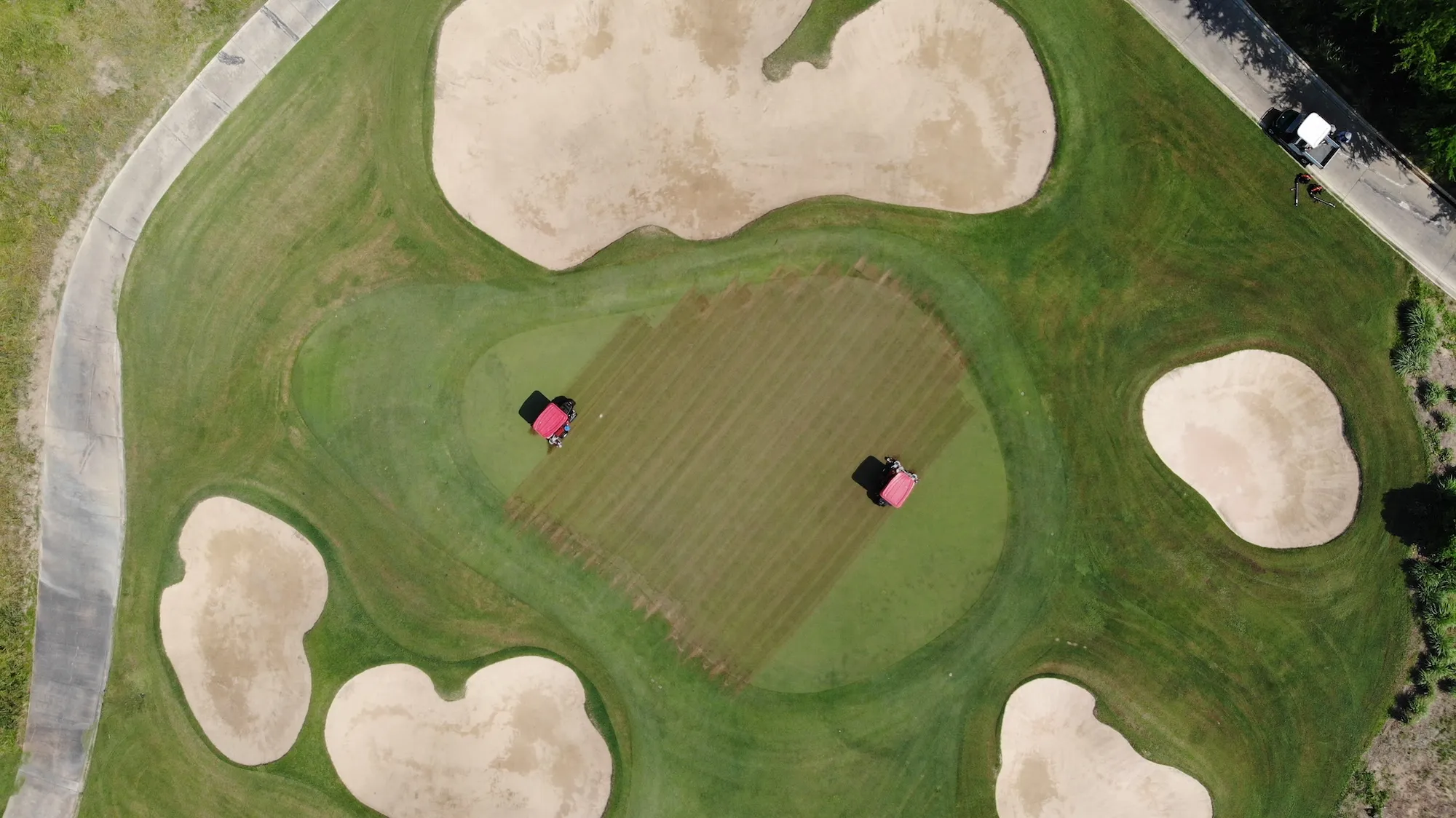 OM246 testing - verticutting golf course greens aerial view.