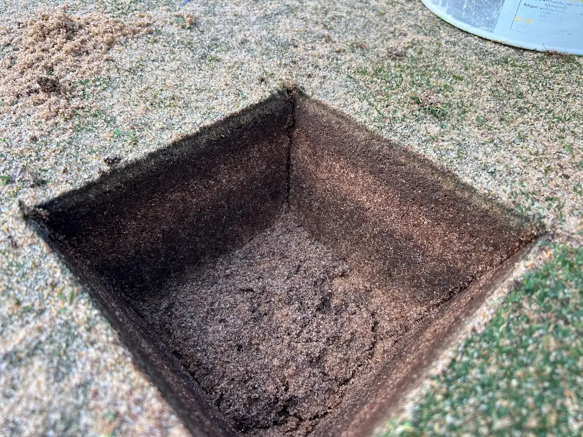 Visible layering in the soil profile of a golf putting green