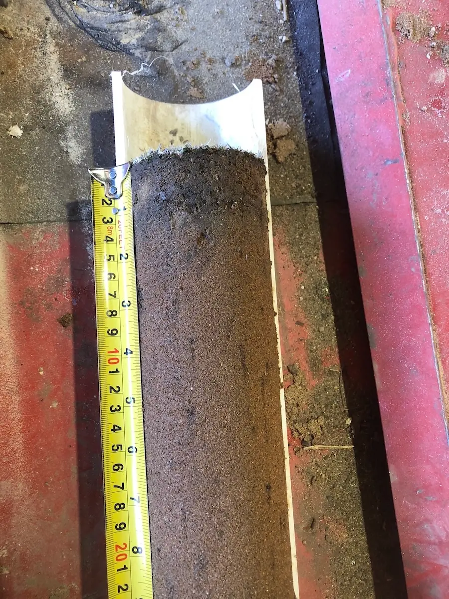 Collecting a core profile sample from a golf green.