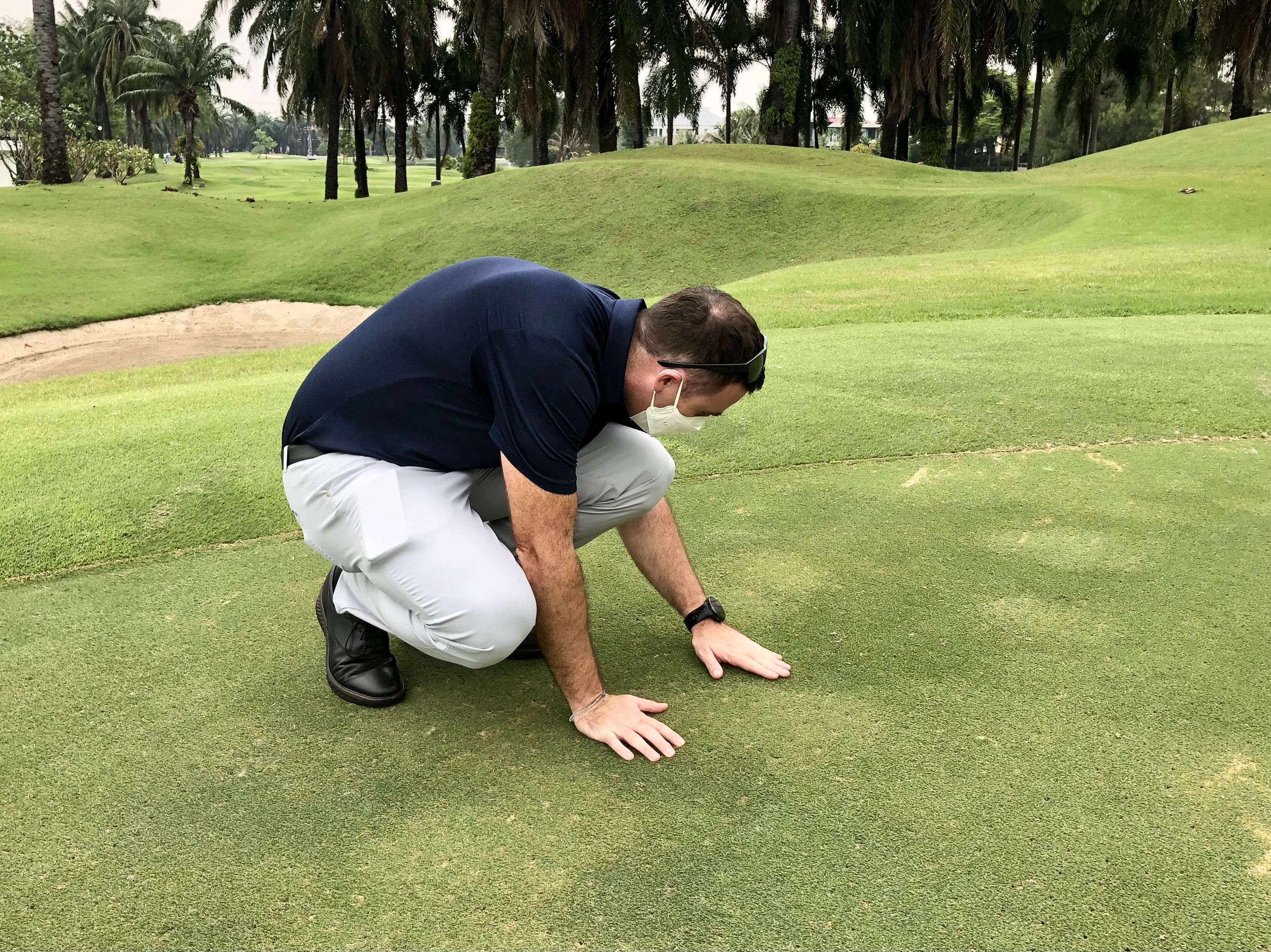 Brad Revill inspecting a golf green turf surface condition